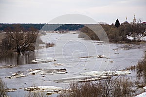 Slowly, small ice floes float down the river. Spring, snow melts