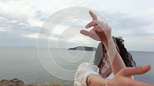Slowmo portrait of young adult woman dancing on sea background