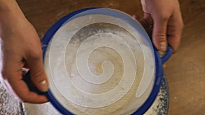 Slowmotion. Close-up of flour through a sieve fray. Sifting flour. Baking. Ingredients and preparation stages. Wheat