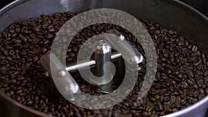 Slowmotion of coffee beans process at roasting plant. Freshly roasted cafe
