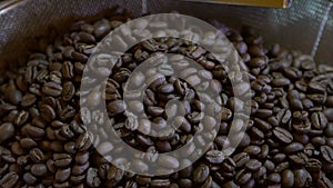 Slowmotion of coffee beans process at roasting plant. Freshly roasted cafe