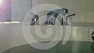 Slowmotion of Running Hot Water and Steam in Bathtub With Faucet, Close Up