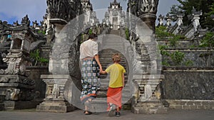 Slowmotion shot of a tourists father and son visiting the Pura Lempuyang Temple at the Bali island, Indonesia