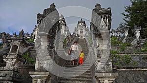 Slowmotion shot of a tourists father and son visiting the Pura Lempuyang Temple at the Bali island, Indonesia