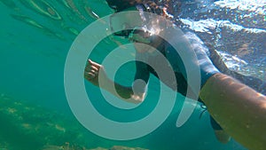 Slowmotion shot of a young man snorkeling in a sea