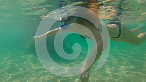 Slowmotion shot of a young woman snorkeling in a sea