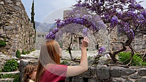 Slowmotion video. A young woman and her son visit the ruins of the Bar old city or Stari Grad. A destroyed ancient