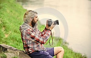 SLR camera. hipster man with beard use professional camera. photographer hold retro camera. journalist is my career