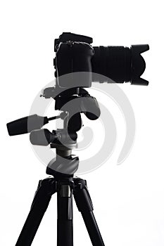 SLR camera on tripod isolated on white