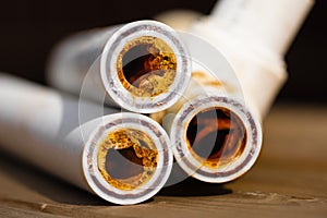 Sludge polypropylene plumbing pipes with rust and limescale. Corrosion and hard water concept. Rust broken water pipes