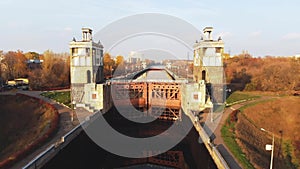 Sluice Gates on the River. Aerial view barge, ship in the river gateway. River sluice construction, water river gateway