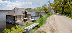 sluice house on the dam of the pond - wooden house on the water by the shore of the Olsina pond, Czech republic