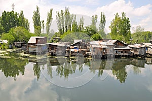 Slum houses near the river, Srinagar, India photo