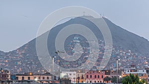 Slums on the slope of hill San Cristobal on the northern side of the river Rimac day to night timelapse. Lima, Peru