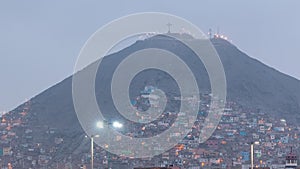 Slums on the slope of hill San Cristobal on the northern side of the river Rimac day to night timelapse. Lima, Peru photo