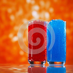 Slush ice in glasses, red and blue on glitter star background