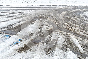 Slushy snow melting on the road