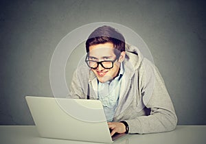 Sly devious man using a laptop plotting server sabotage