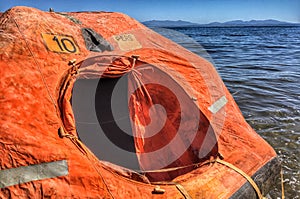 A smal life raft floating on the sea