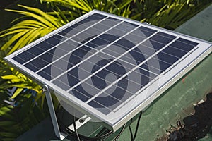 A small 50 watt Polycrystalline solar panel mounted on the edge of the roof of a house for an off-grid light
