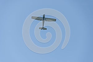 Small aeroplane flying on blue sky background over Sredna Gora mountain