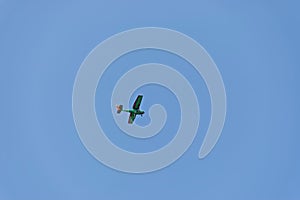 Small aeroplane flying on blue sky background over Sredna Gora mountain