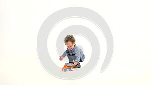 Small African American is playing a machine and laughing. White background. Slow motion