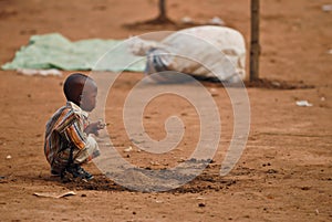 Small african boy squatting