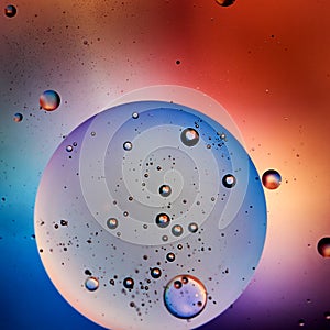 Small air bubbles in a big oil sphere, blue and red colors