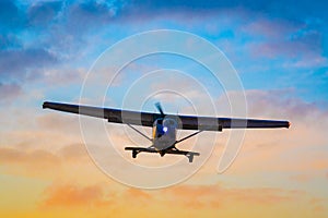 Small Aircraft Lands at Sunset