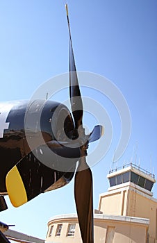 Small Airplane at Airport With Airport Tower in Background