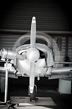 Small airplane in hangar