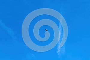 Small airplane or light aircraft flying across the blue sky