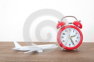 Small airplane model and alarm clock on the table