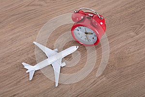 Small airplane model and alarm clock on the table