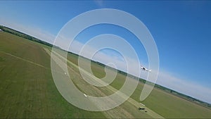 Small airplane with propeller engines flying in a clear blue sky. Aerial view to lightweight plane flight above rural