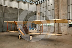 Small airplane with propeller in front parking in terminal.