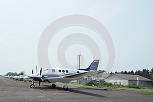 The small airplanes are lined up at Doylestown Airport.