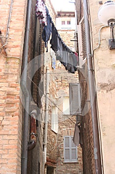Small alley with hanging clothes in Urbino downtown