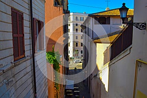 Small alley in middle of Rome, Italy, with a cafe bar with table