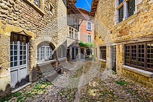 Small alley at Perouges village in France during a sunny day