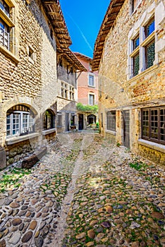 Small alley at Perouges village in France during a sunny day