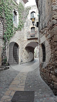 A small alley surrounded by stone walls in a village in spain