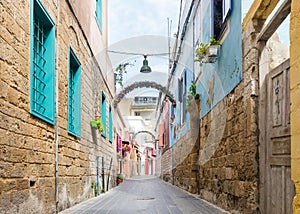 Small alleyway with colorful houses, Christian quarter in the Mediterranean coastal town Tyre, Lebanon