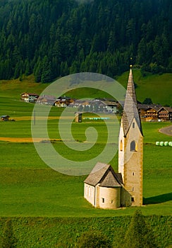 Small Alpine Church in Green Field