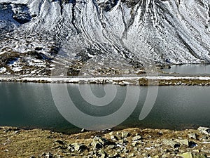 A small alpine lake Lai Nair (Black Lake or Schwarzer See) on the mountain road pass Fluela (FlÃ¼elapass) photo