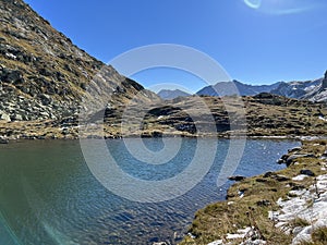 A small alpine lake Lai Nair (Black Lake or Schwarzer See) on the Swiss mountain road pass Fluela (Fluelapass)