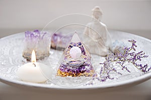 Small altar with Orgonite or Orgone pyramid in home interior. Converting negative energy to positive energy and have healing power