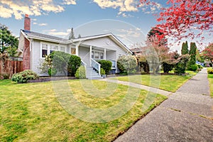 Small American home with light exterior and white trim.