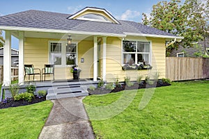 Small American yellow house exterior photo